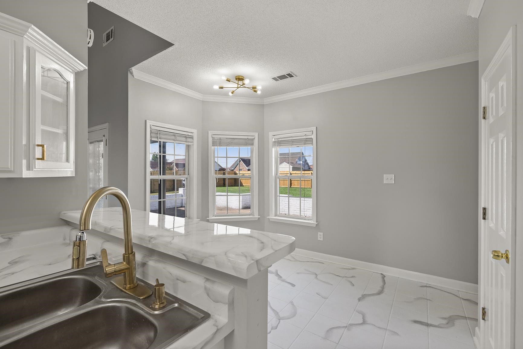 369 Rosemark Road Atoka, TN 38004 - Photo 9 of 27 a kitchen with a sink and chandelier