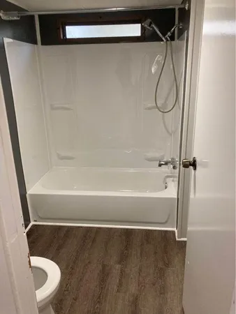 a bathroom with a shower and a toilet