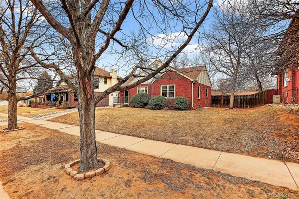 a front view of a house with a yard covered with snow