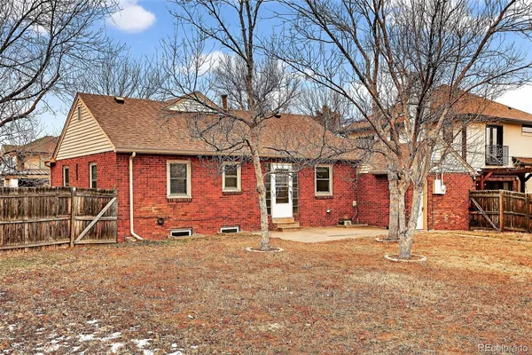 a view of a house with a yard covered in snow