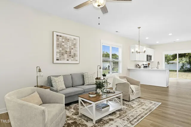 a living room with furniture and kitchen view