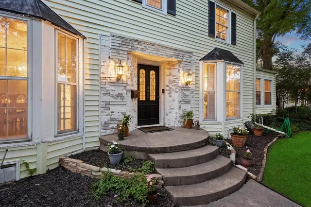 a view of house with backyard and outdoor seating