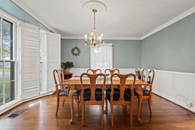 a view of a dining room with furniture window and wooden floor