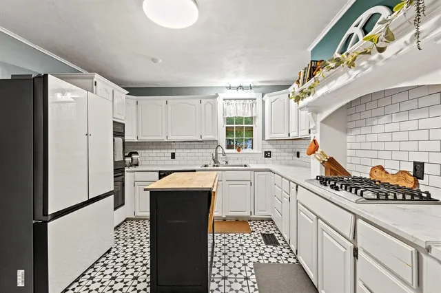 a kitchen with stainless steel appliances a refrigerator sink and cabinets