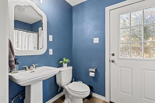 a bathroom with a sink a toilet and mirror