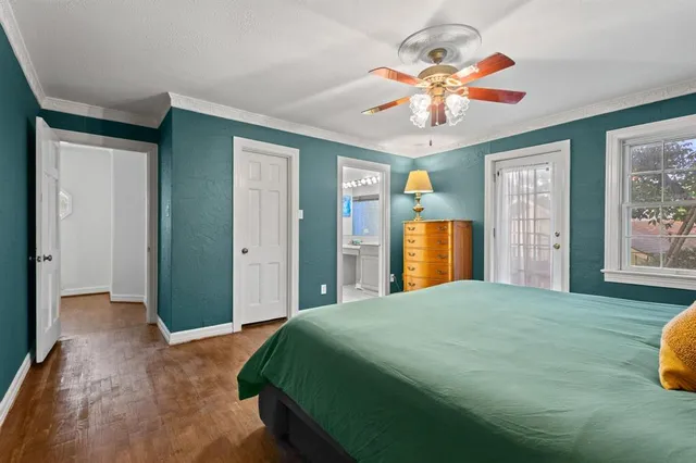 a bedroom with a large bed a chandelier and closet