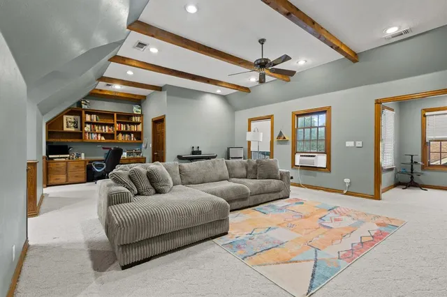 a living room with furniture a ceiling fan and a rug