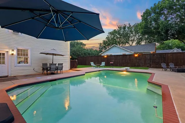a view of a swimming pool with a patio