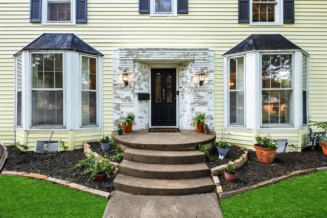 a front view of a house with garden