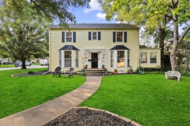 a front view of a house with a garden