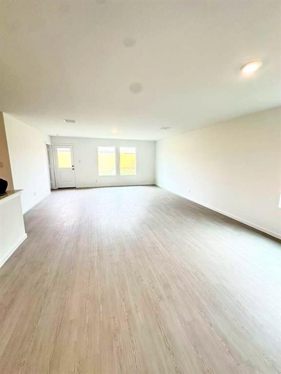 11570 Antrrim Place Place Rhome, TX 76078 - Photo 3 of 17 an empty room with wooden floor and windows