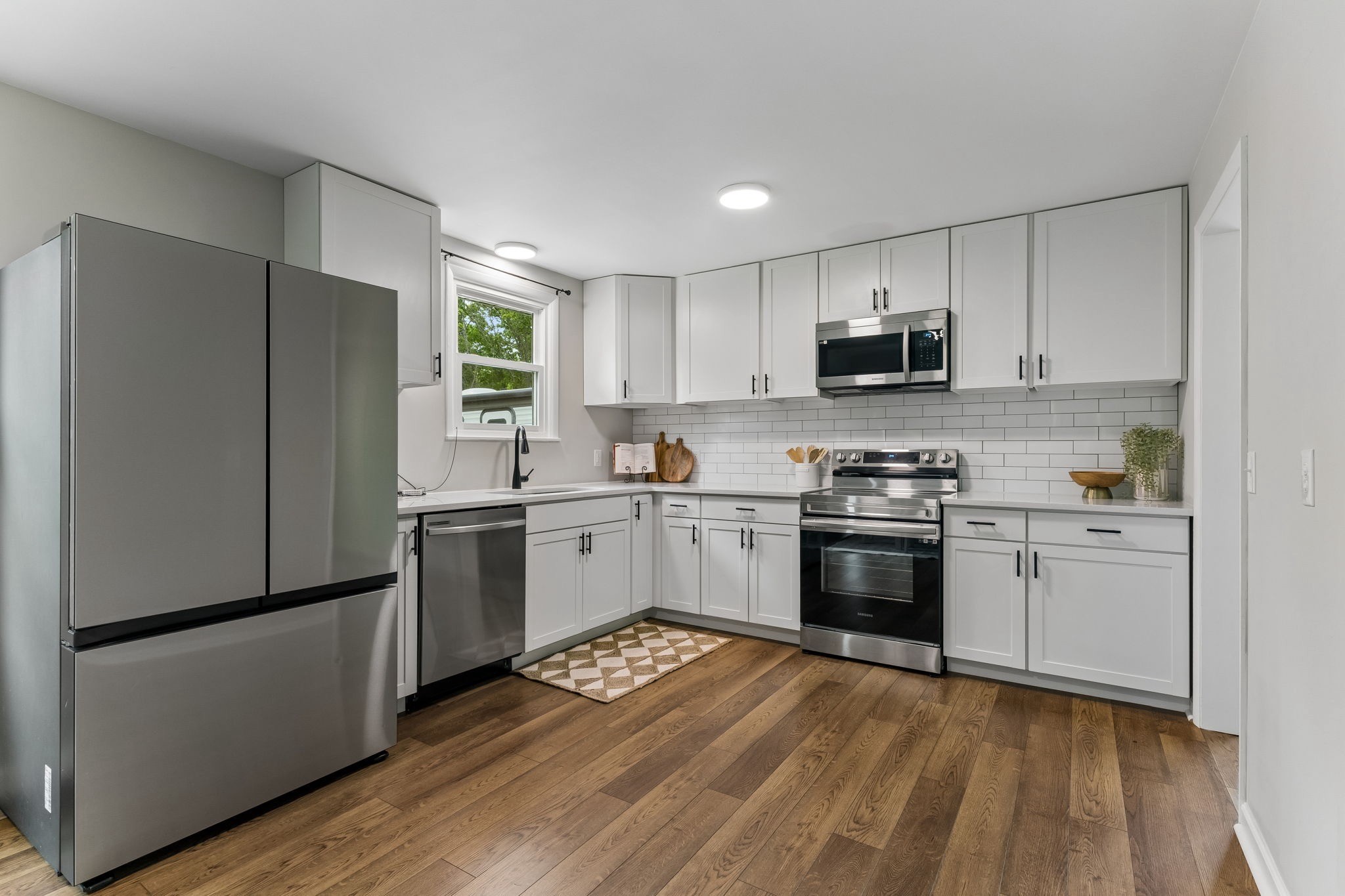 3908 Cedar Street Centerville, TN 37033 - Photo 8 of 31 a kitchen with a refrigerator stove and wooden cabinets