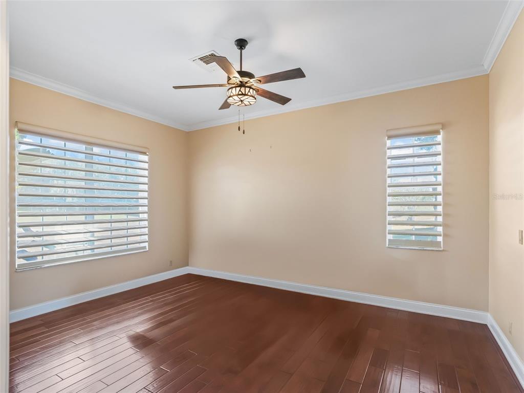 1412 Meadow View Way Lady Lake, FL 32159 - Photo 18 of 37 a view of an empty room with wooden floor and a window