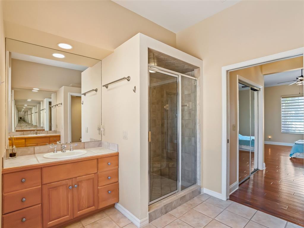 1412 Meadow View Way Lady Lake, FL 32159 - Photo 22 of 37 a spacious bathroom with a shower sink and mirror