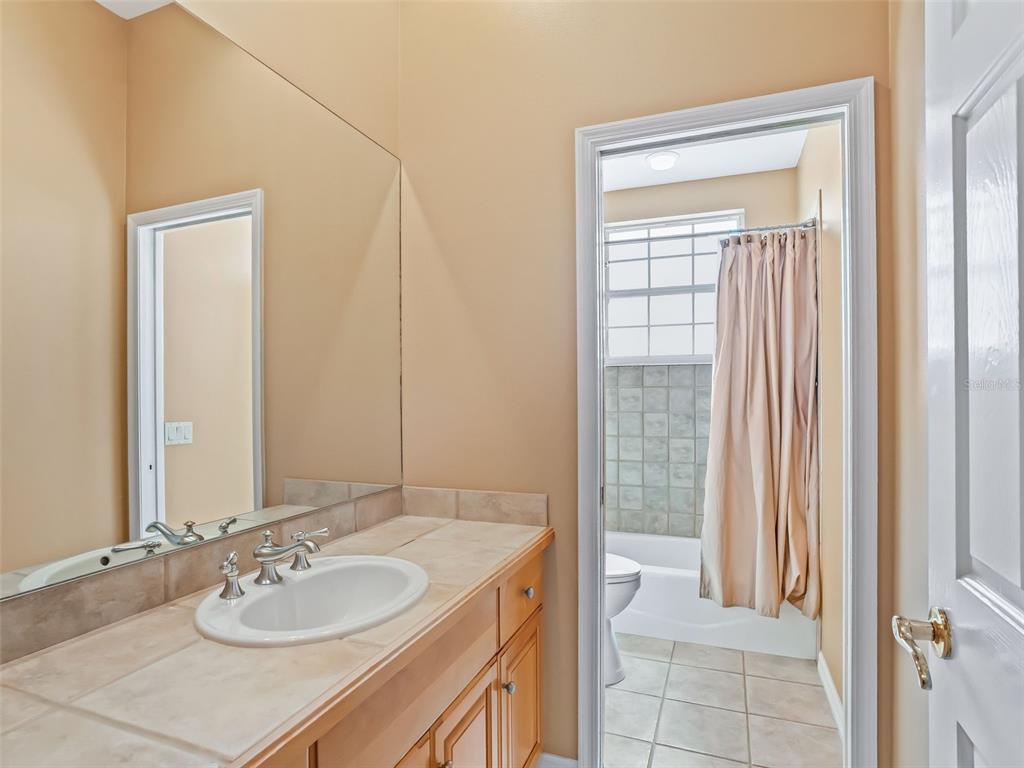 1412 Meadow View Way Lady Lake, FL 32159 - Photo 27 of 37 a bathroom with a sink and a mirror