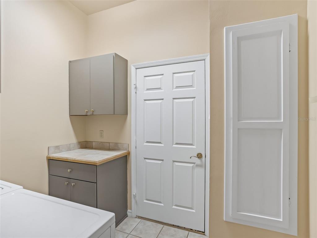 1412 Meadow View Way Lady Lake, FL 32159 - Photo 33 of 37 a bathroom with a sink a toilet and mirror