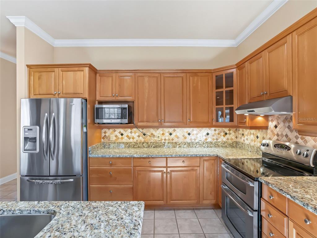 1412 Meadow View Way Lady Lake, FL 32159 - Photo 7 of 37 a kitchen with a sink stove and refrigerator