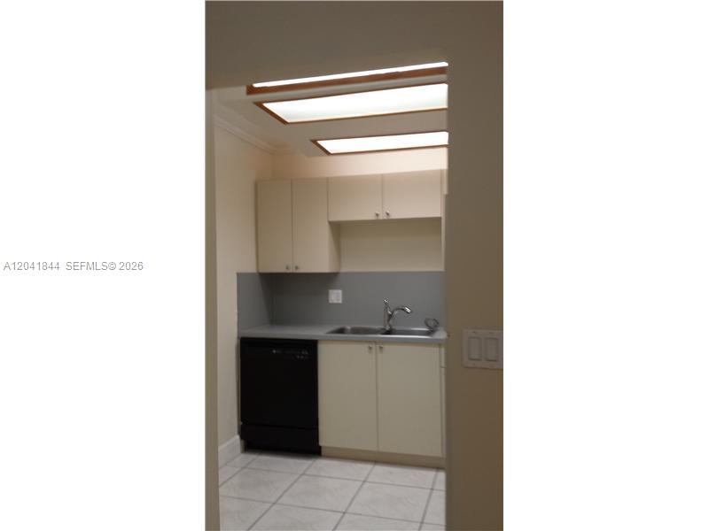 8610 Southwest 149th Avenue, Unit 504 Miami, FL 33193 - Photo 8 of 13 a kitchen with a sink and cabinets