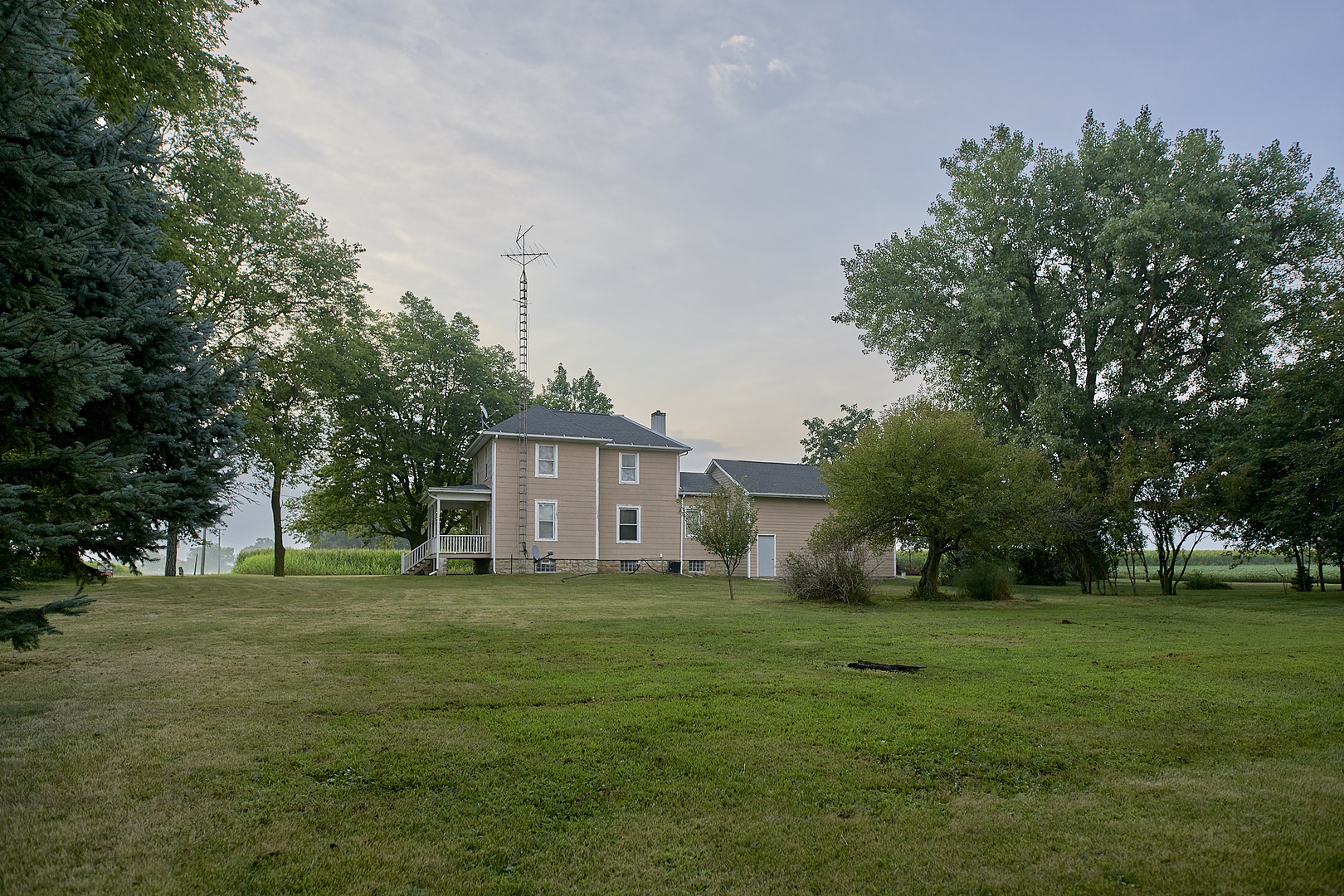 29721 East 3200 North Road Blackstone, IL 61313 - Photo 5 of 23 a view of a big yard with a house in the background