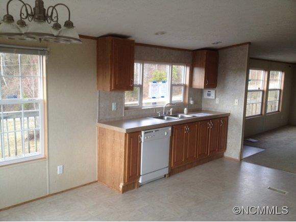 1121 Kerr Road Hendersonville, NC 28792 - Photo 4 of 10 a kitchen with a sink cabinets and window