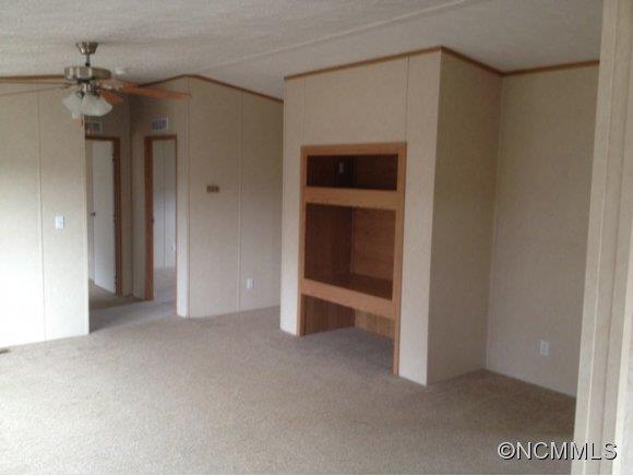 1121 Kerr Road Hendersonville, NC 28792 - Photo 6 of 10 a view of an empty room with a fireplace