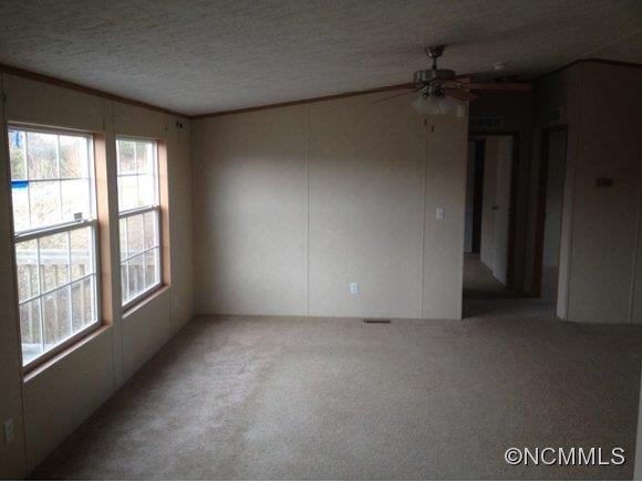 1121 Kerr Road Hendersonville, NC 28792 - Photo 7 of 10 an empty room with a empty space and windows
