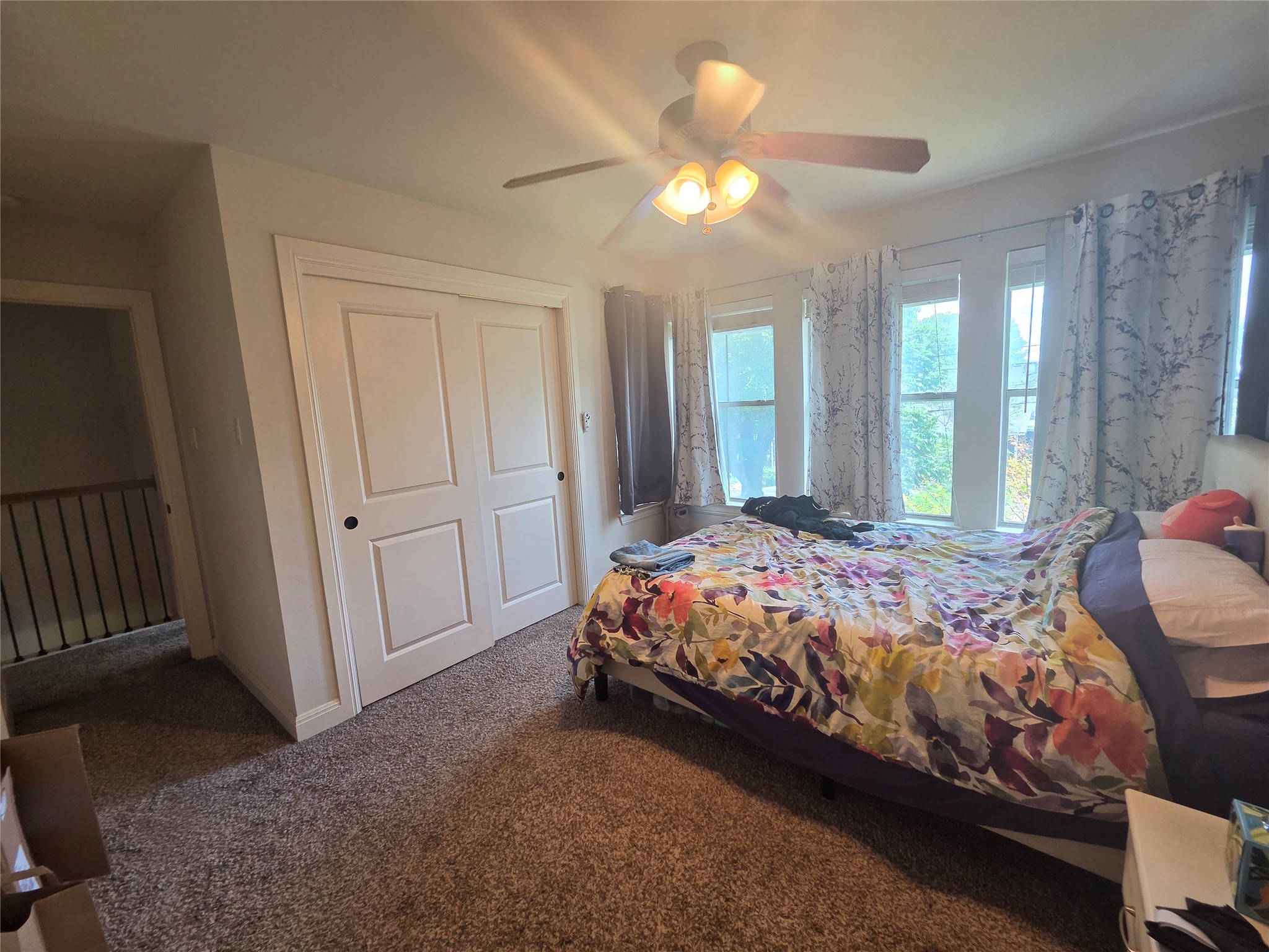 408 West Croslin Street Austin, TX 78752 - Photo 24 of 29 Comfortable carpeting and a ceiling fan create a serene atmosphere for this well-lit bedroom space.