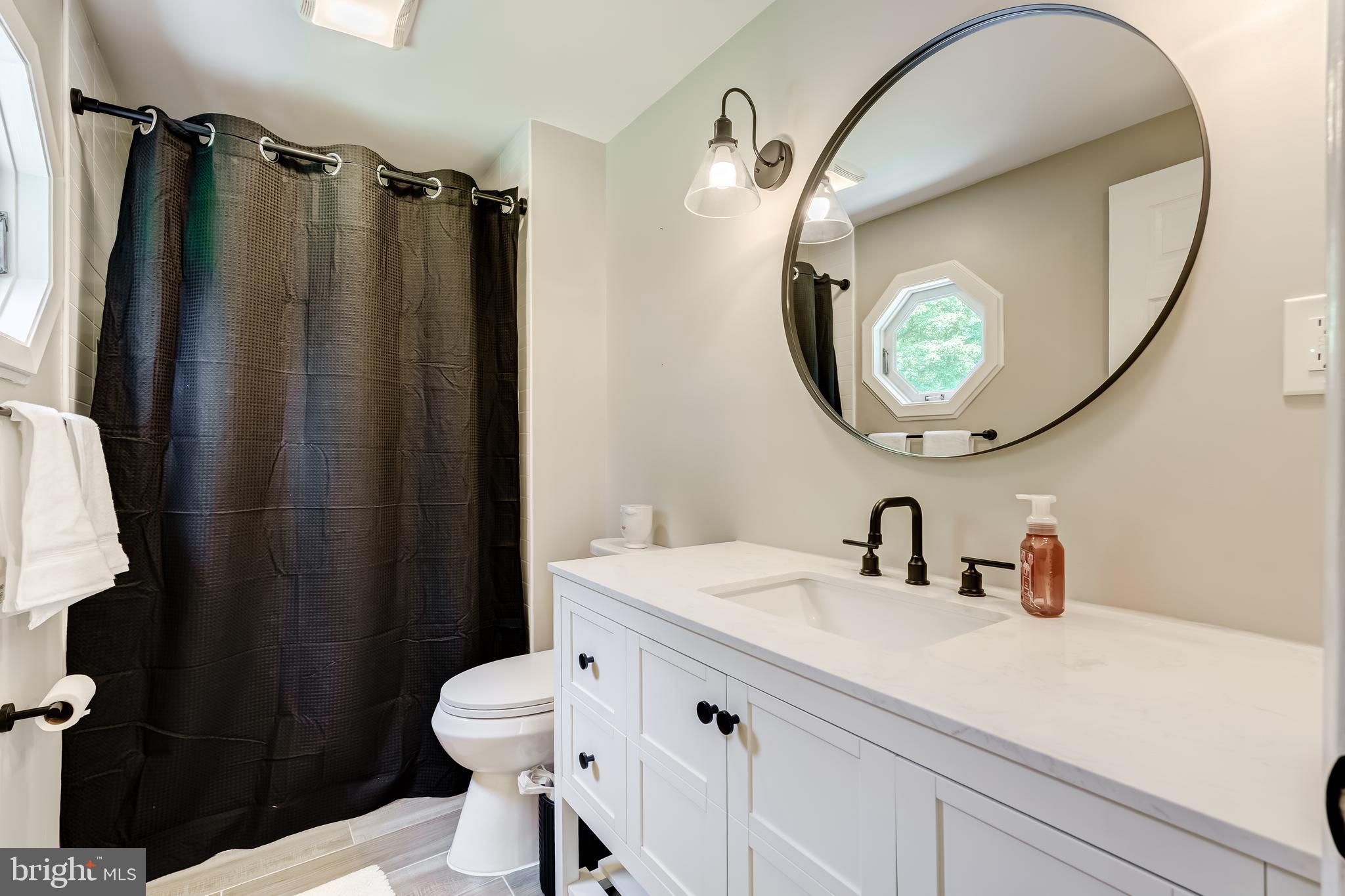 11926 Appling Valley Road Fairfax, VA 22030 - Photo 7 of 60 a bathroom with a sink mirror toilet and vanity
