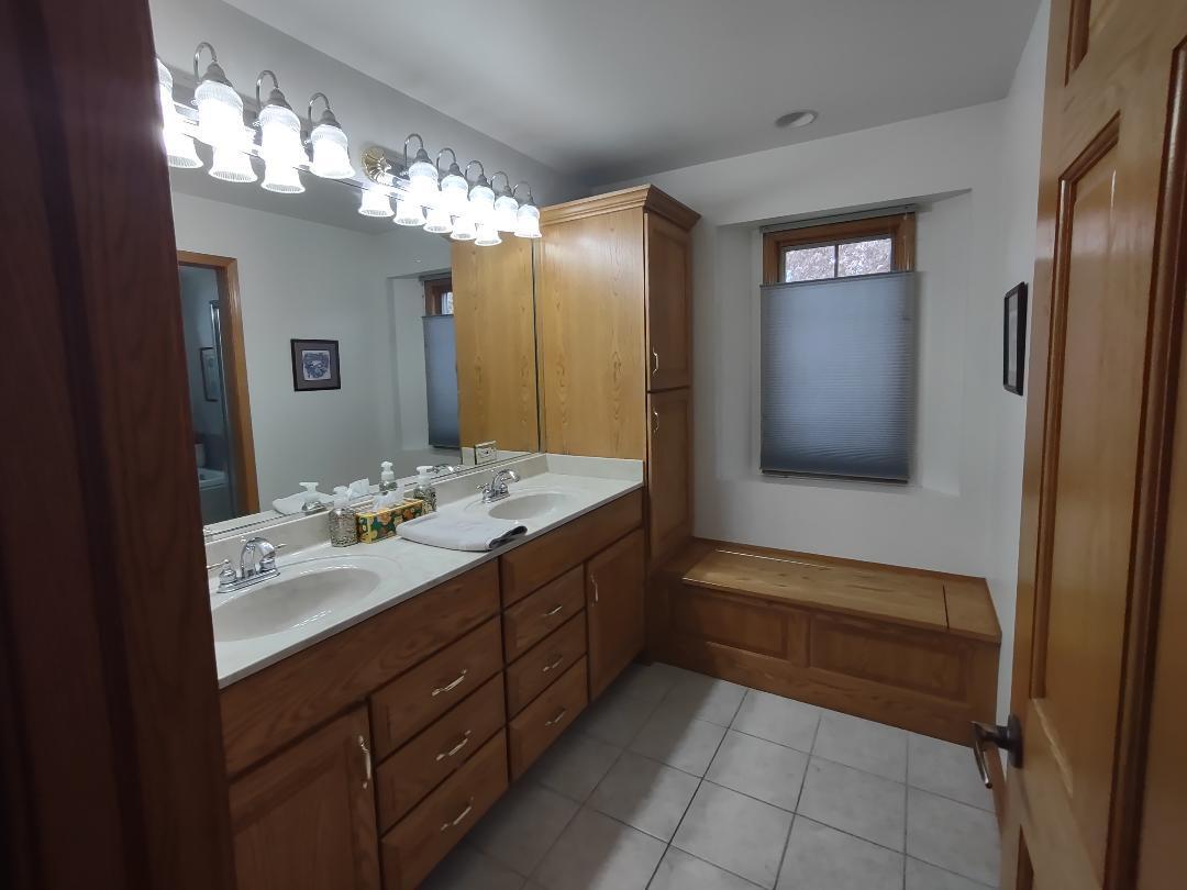9800 Crestwood Circle Demotte, IN 46310 - Photo 13 of 25 a bathroom with a sink vanity and mirror