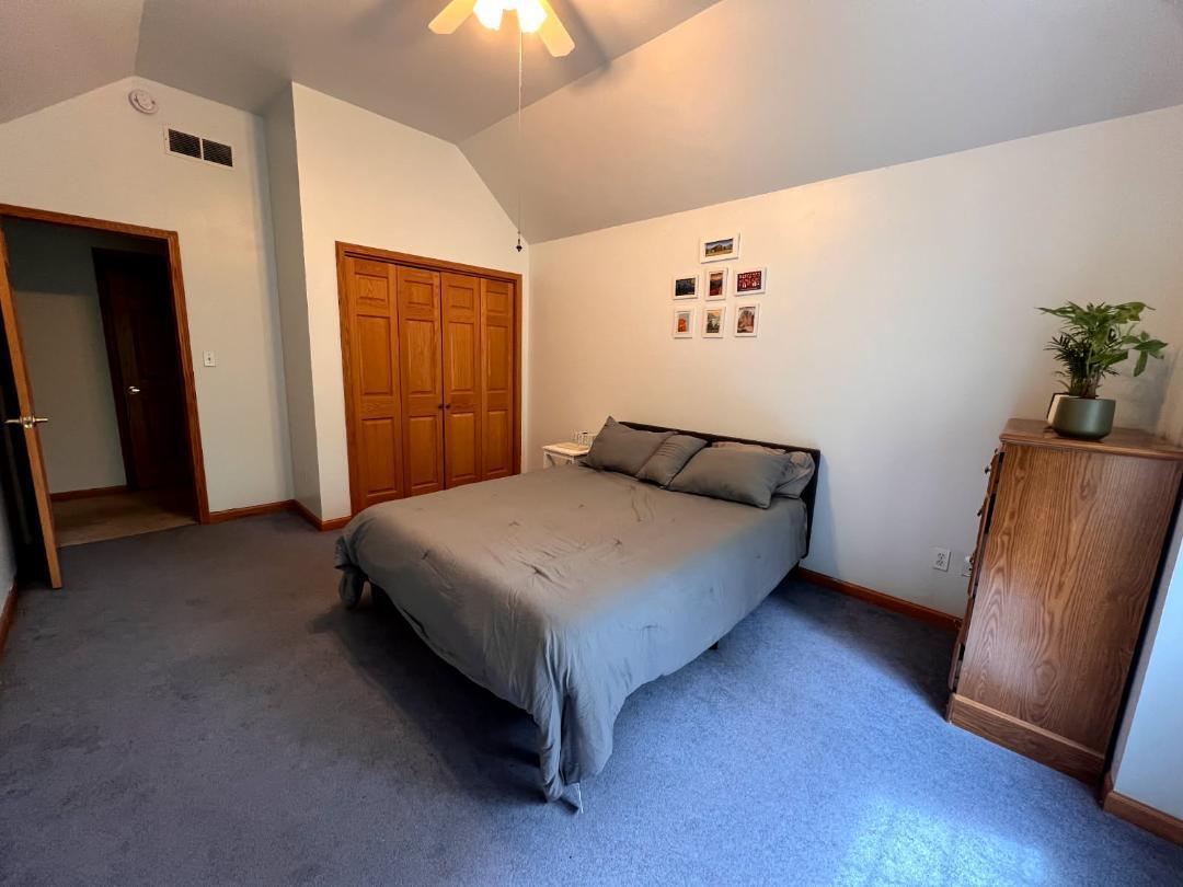 9800 Crestwood Circle Demotte, IN 46310 - Photo 16 of 25 a bedroom with a bed and wooden floor