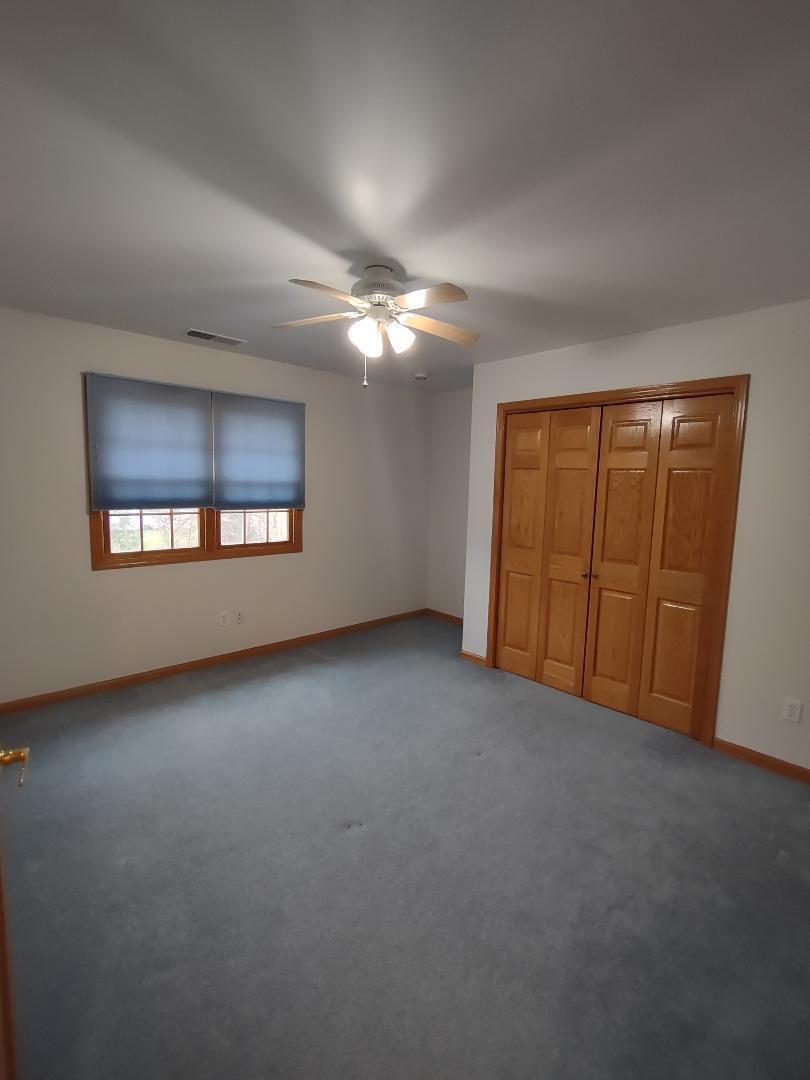 9800 Crestwood Circle Demotte, IN 46310 - Photo 17 of 25 an empty room with windows and ceiling fan