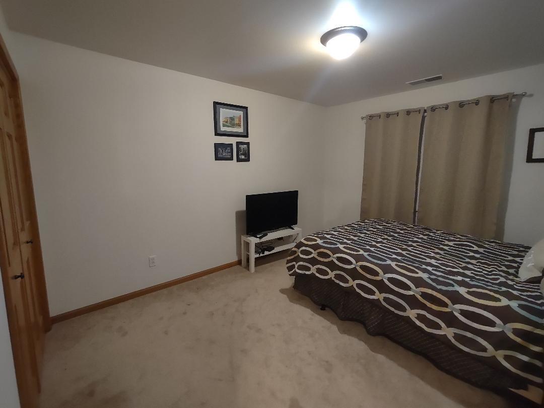 9800 Crestwood Circle Demotte, IN 46310 - Photo 18 of 25 a bedroom with a bed and a window