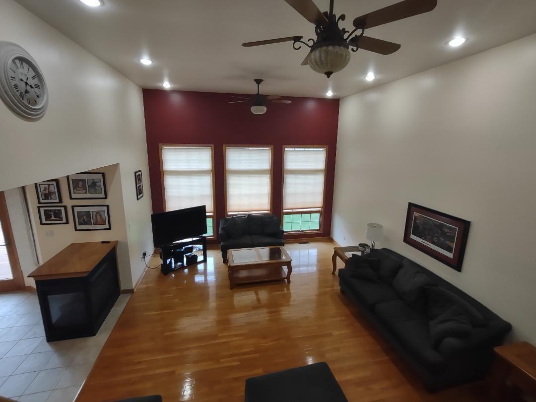 9800 Crestwood Circle Demotte, IN 46310 - Photo 10 of 25 a living room with furniture and a flat screen tv