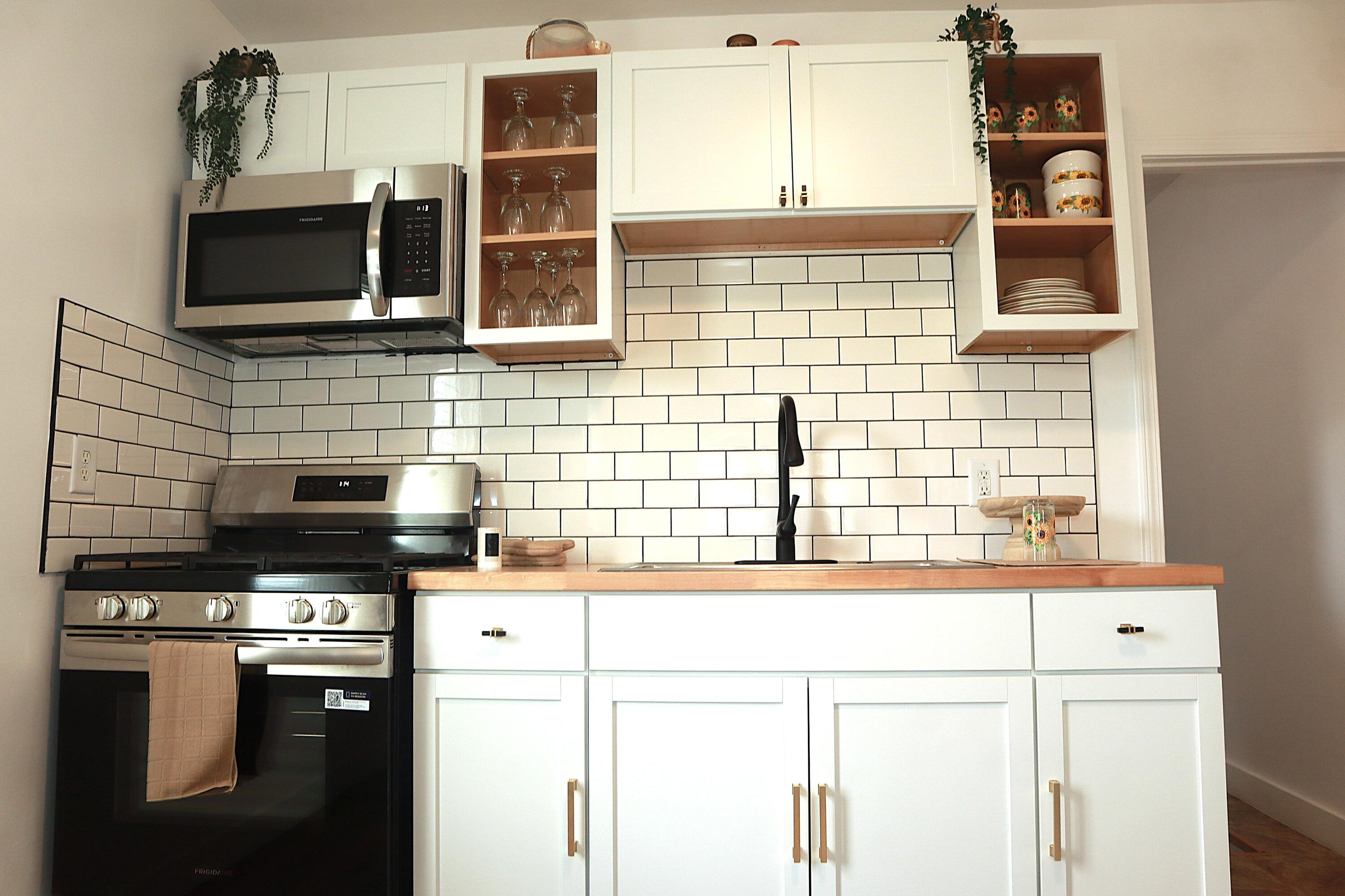 4001 Virginia Street Gary, IN 46409 - Photo 6 of 15 a kitchen with stainless steel appliances a stove and a microwave