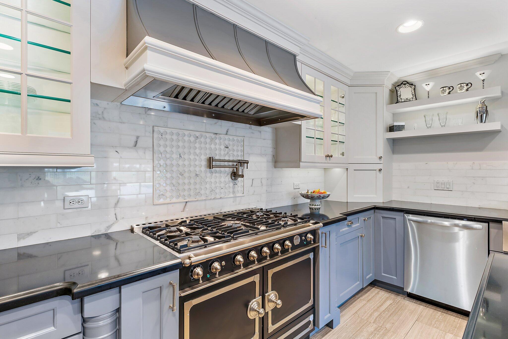 210 Golfview Drive Tequesta, FL 33469 - Photo 11 of 27 a kitchen with stainless steel appliances granite countertop a stove and a sink