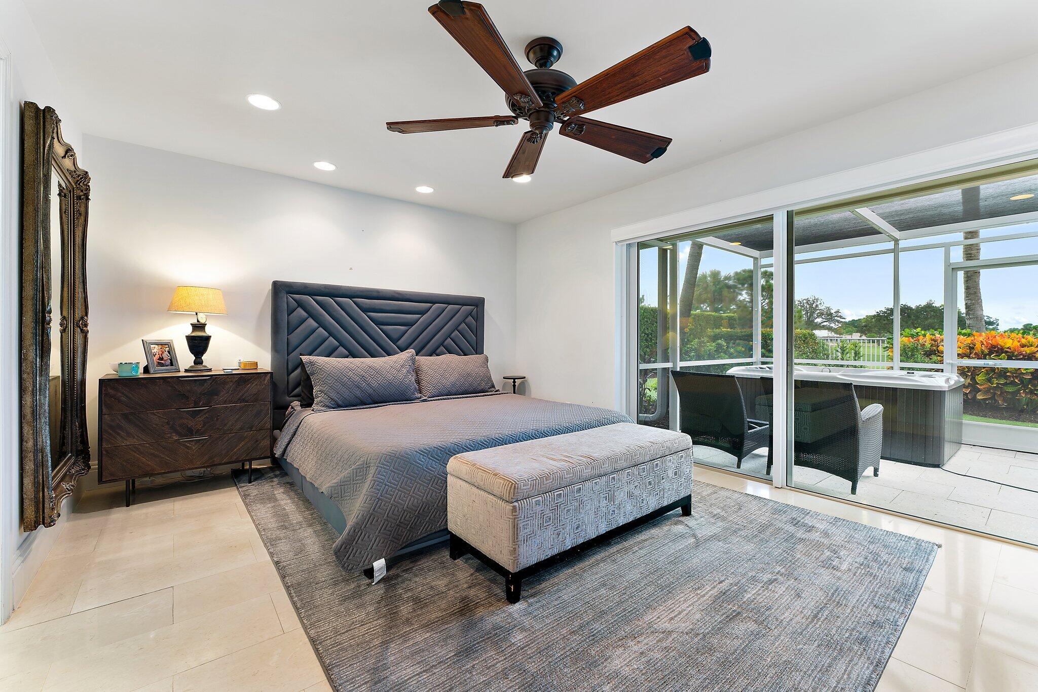 210 Golfview Drive Tequesta, FL 33469 - Photo 15 of 27 a spacious bedroom with a bed and large window