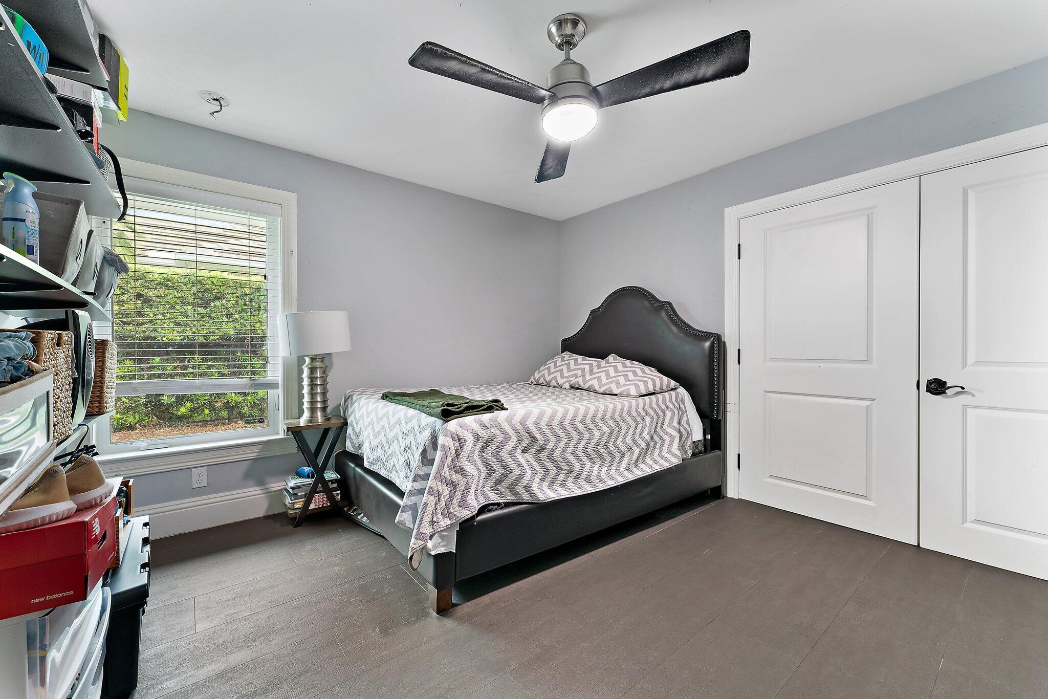 210 Golfview Drive Tequesta, FL 33469 - Photo 18 of 27 a spacious bedroom with a bed and a window