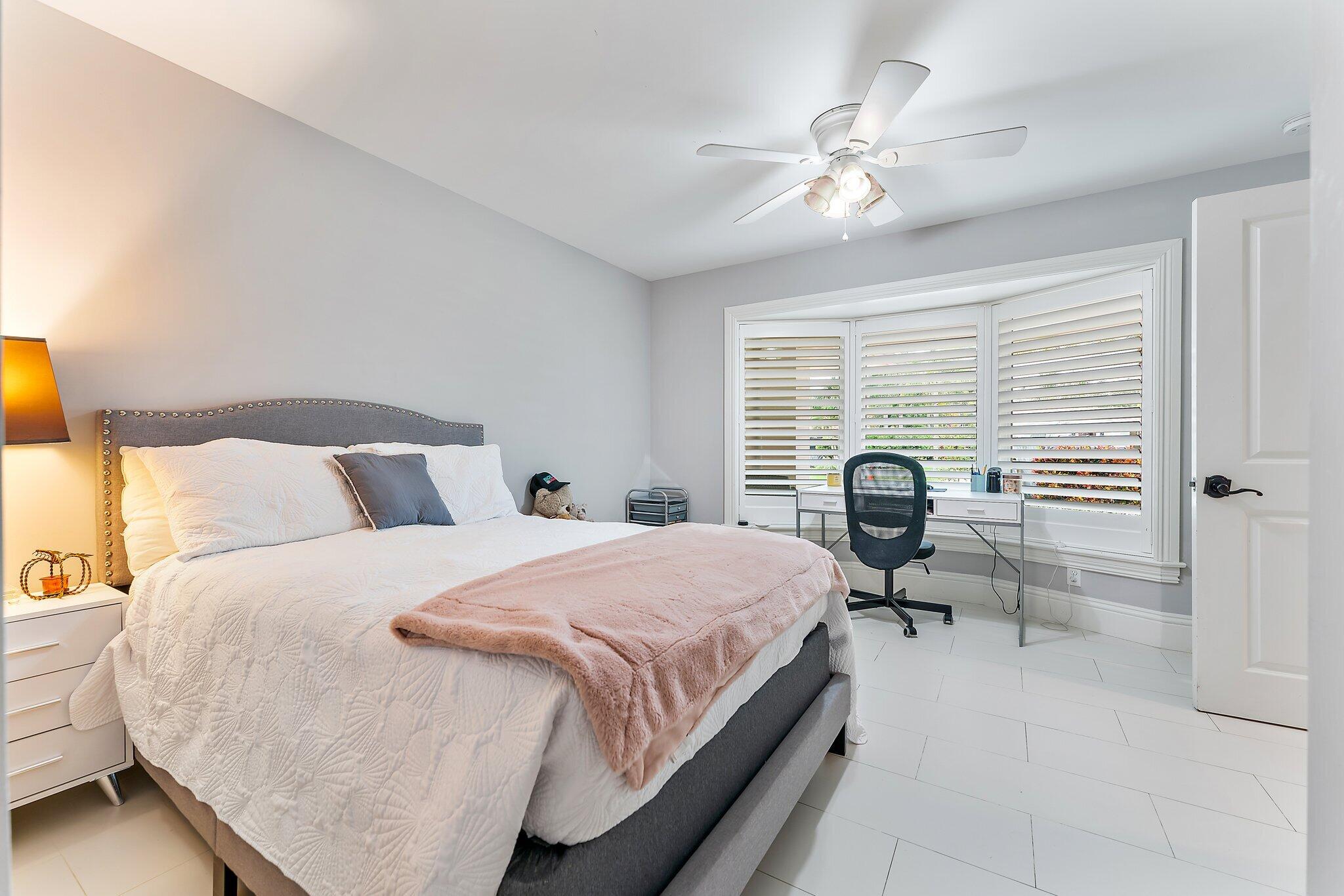 210 Golfview Drive Tequesta, FL 33469 - Photo 19 of 27 a bedroom with a bed and a large window