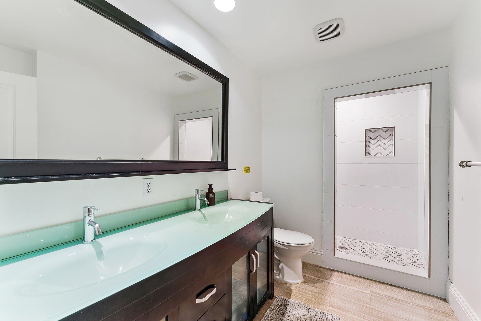 210 Golfview Drive Tequesta, FL 33469 - Photo 20 of 27 a bathroom with a sink a toilet and shower