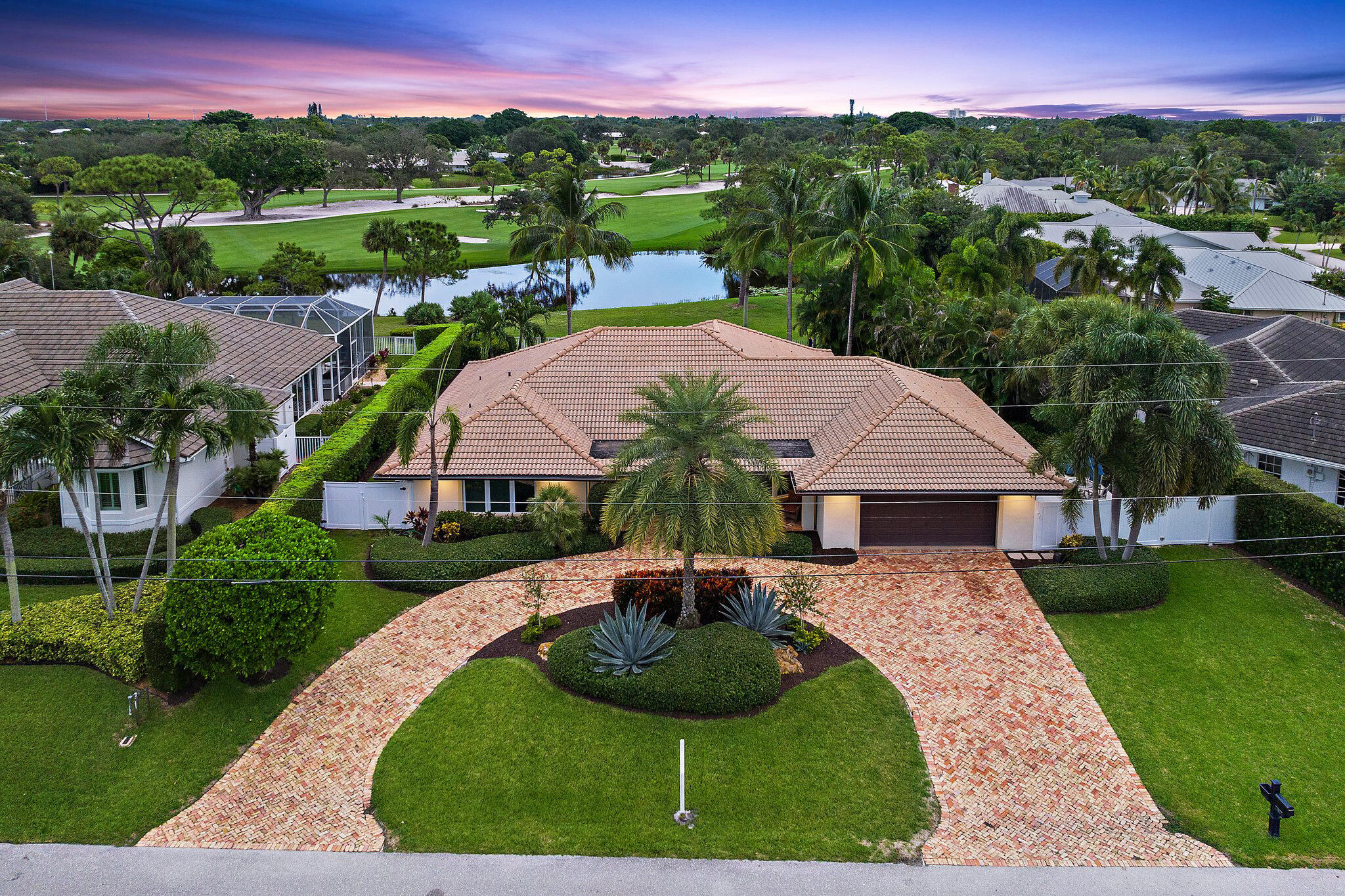 210 Golfview Drive Tequesta, FL 33469 - Photo 26 of 27 a view of a garden with a swimming pool