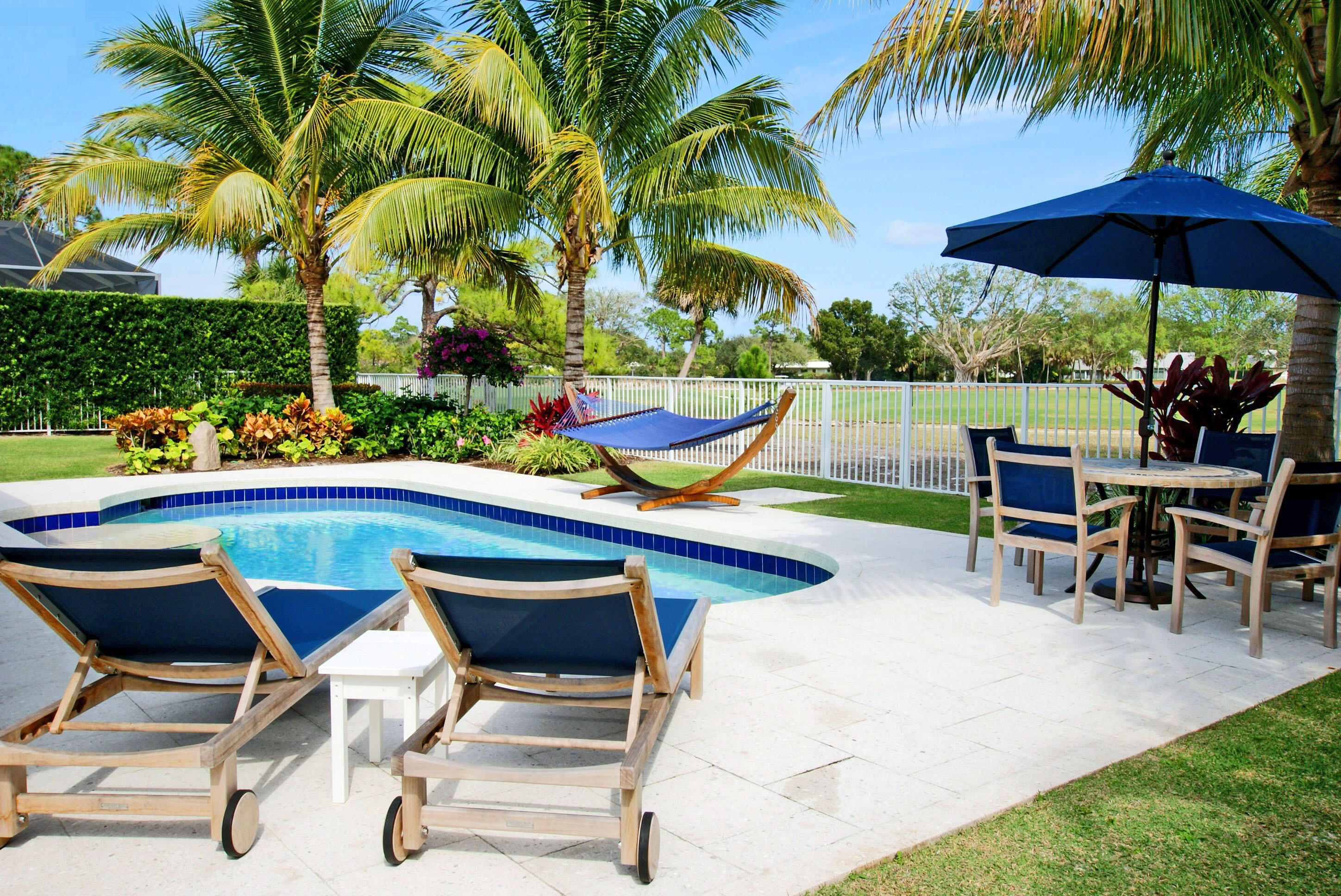 210 Golfview Drive Tequesta, FL 33469 - Photo 4 of 27 a view of a chairs and table in the patio with a fire pit