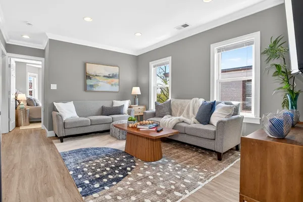 a living room with furniture and a rug