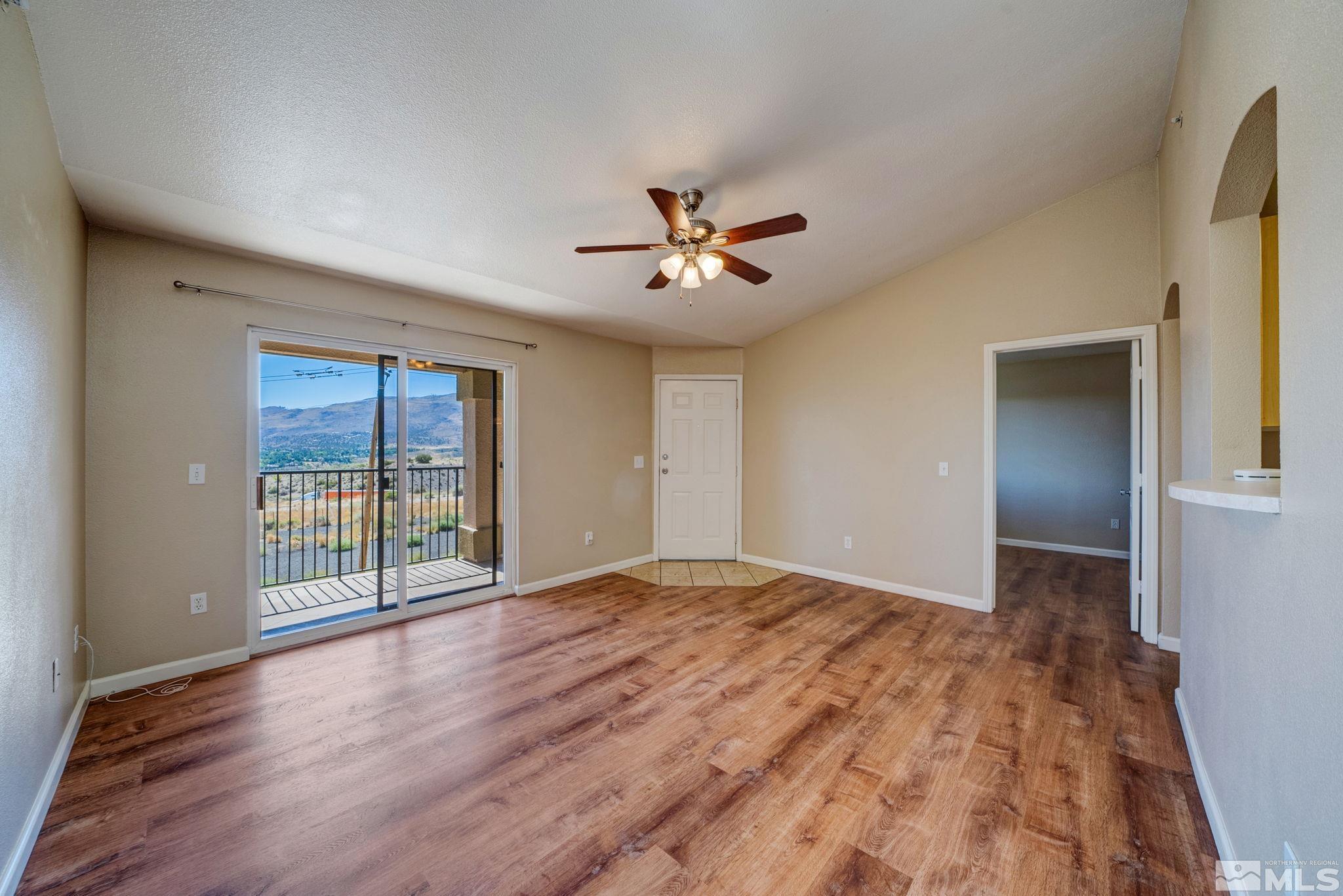 6850 Sharlands Avenue, Unit 2090 Reno, NV 89523 - Photo 8 of 10 a view of an empty room with window and wooden floor