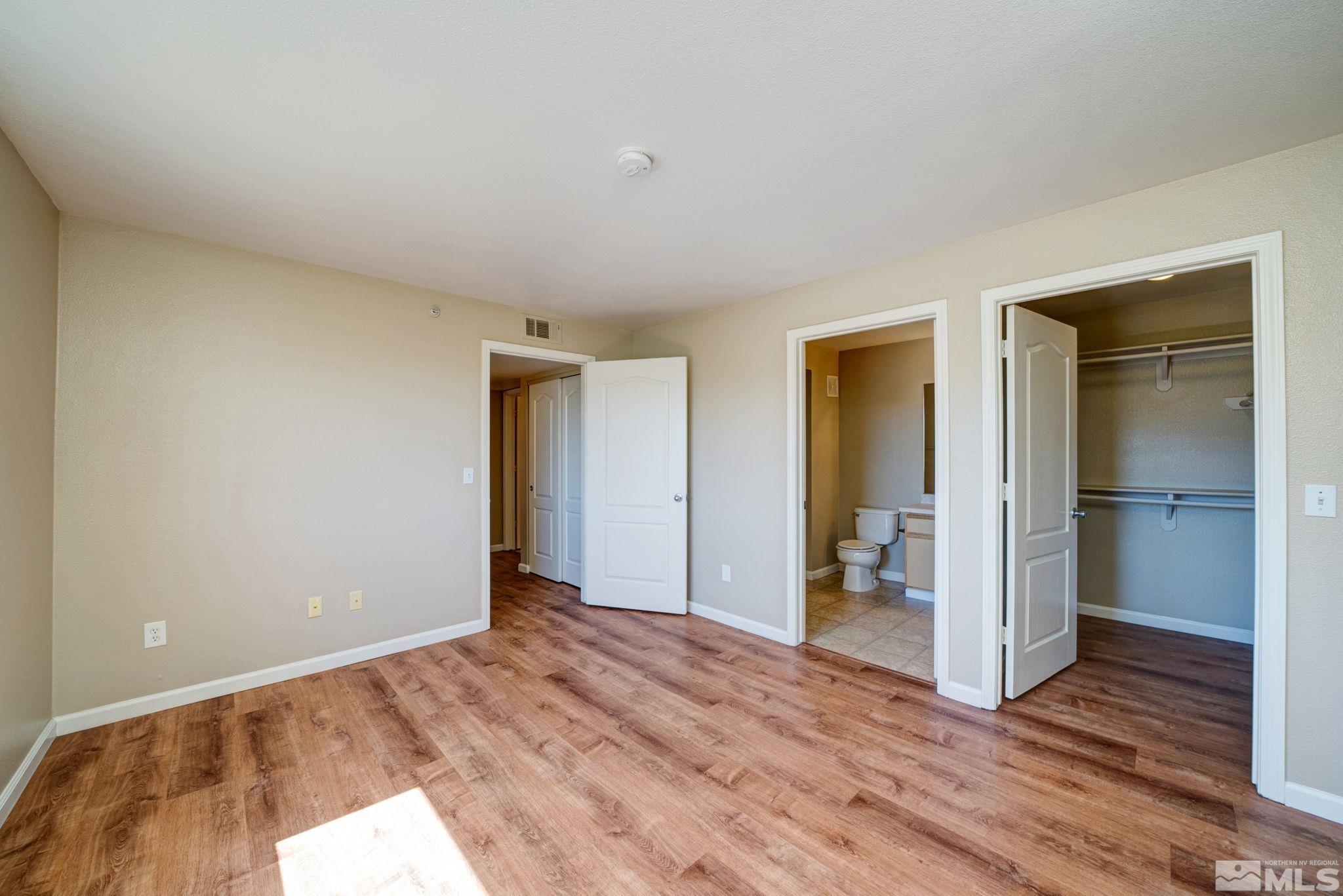 6850 Sharlands Avenue, Unit 2090 Reno, NV 89523 - Photo 9 of 10 an empty room with closet and wooden floor