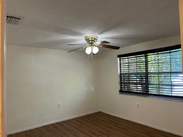 a view of wooden floor and windows in a room