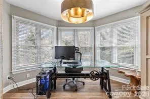 a view of a workspace with furniture and a window