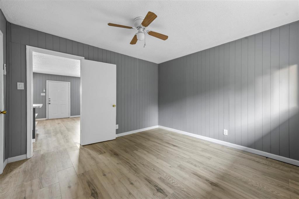 1585 North Mill Street, Unit 5 Lewisville, TX 75057 - Photo 12 of 17 wooden floor in an empty room with a window