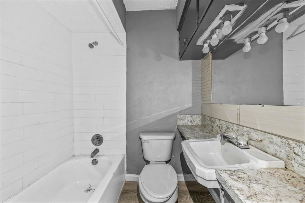 1585 North Mill Street, Unit 5 Lewisville, TX 75057 - Photo 14 of 17 a bathroom with a sink a toilet and bathtub