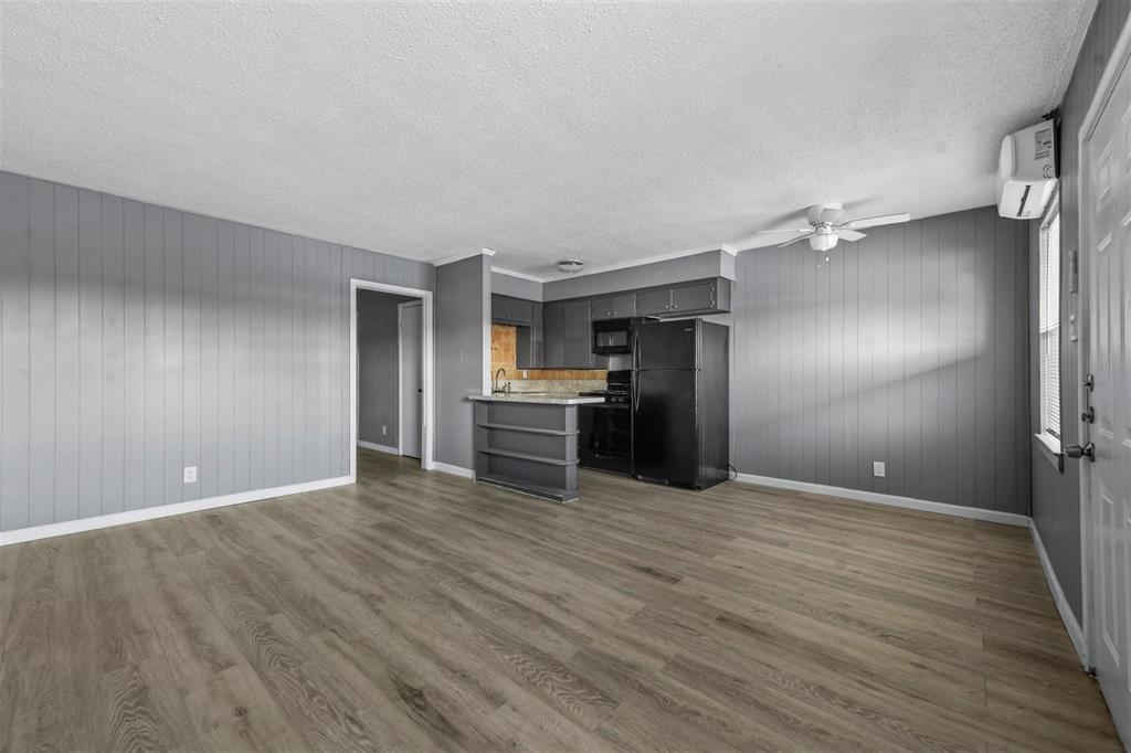 1585 North Mill Street, Unit 5 Lewisville, TX 75057 - Photo 3 of 17 a view of empty room with wooden floor
