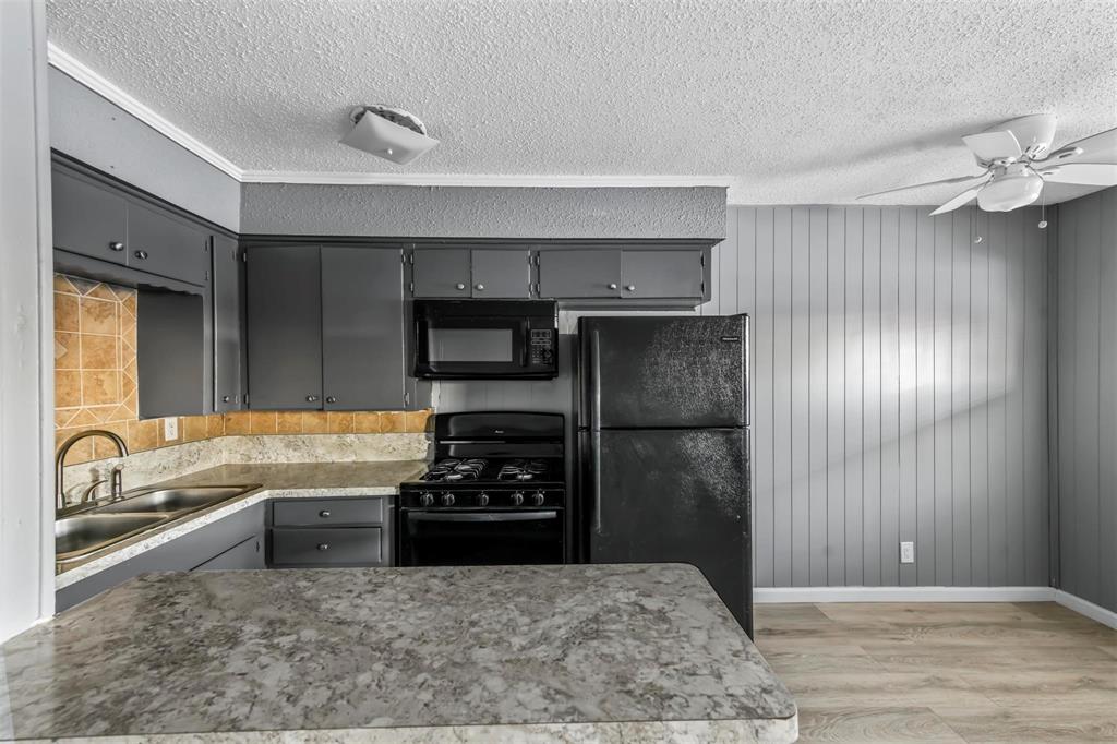1585 North Mill Street, Unit 5 Lewisville, TX 75057 - Photo 5 of 17 a kitchen with a sink stainless steel appliances and cabinets